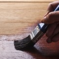 paint-brush-staining-hardwood